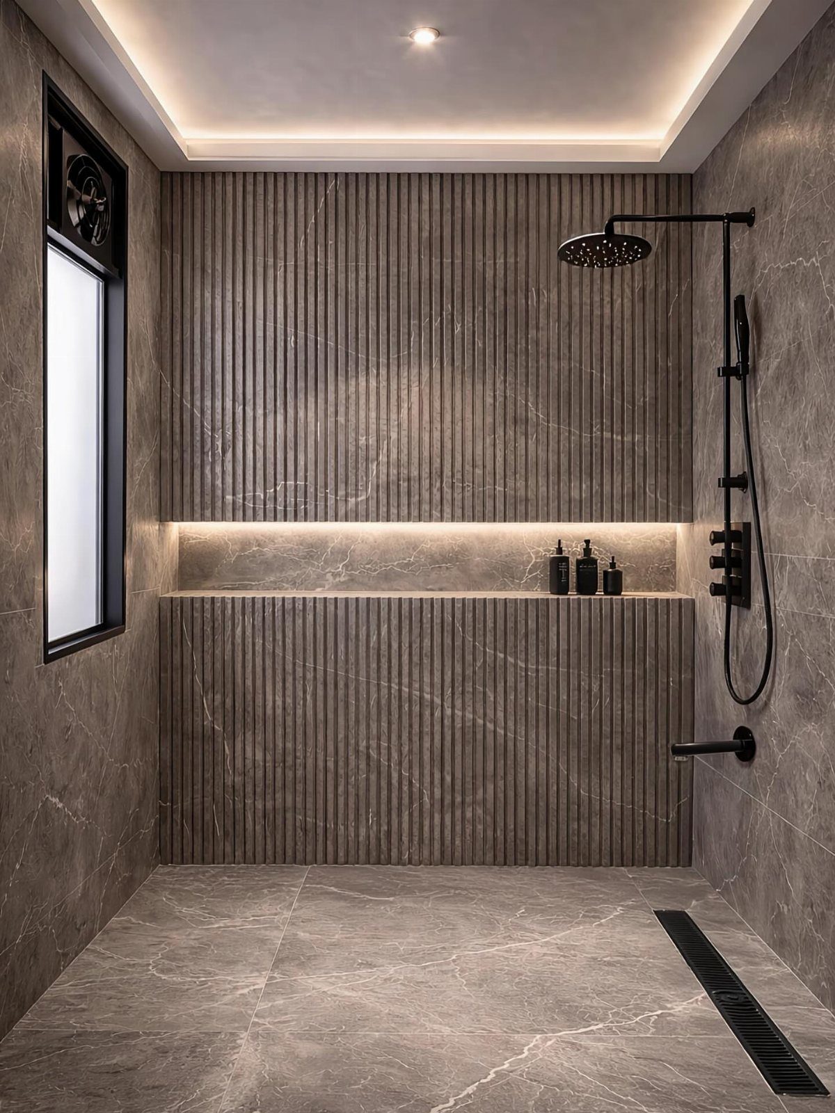 Modern walk-in shower featuring grey marble tiles and vertical fluted wall paneling with black fixtures.