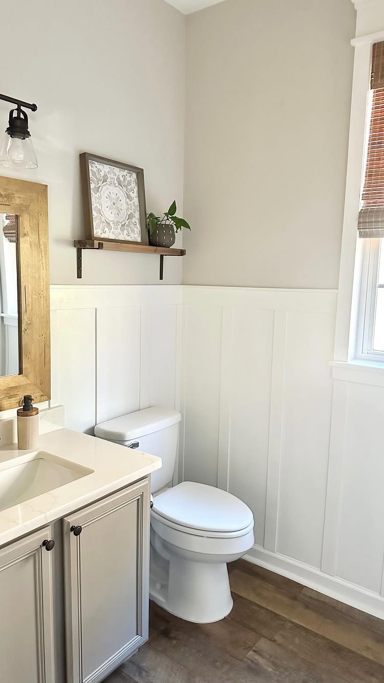 White board and batten wainscoting installed on the lower half of a bathroom wall.