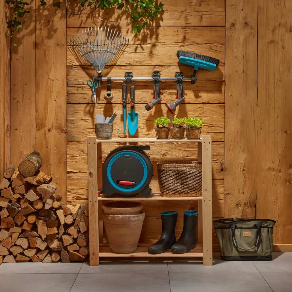 Garden tools and a hose reel organized on a wooden shelf and wall rack.