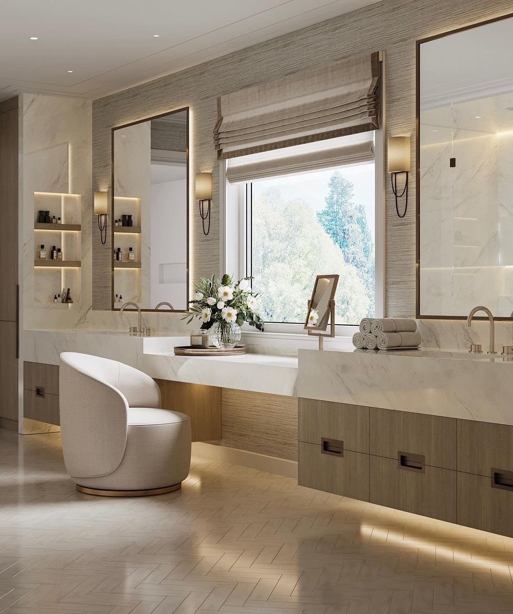 A marble bathroom vanity with a dedicated makeup station and a white chair.