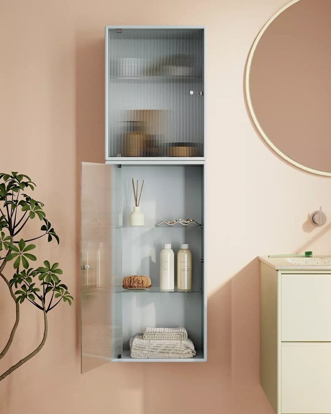 A light blue wall-mounted cabinet with glass doors containing toiletries and folded towels.