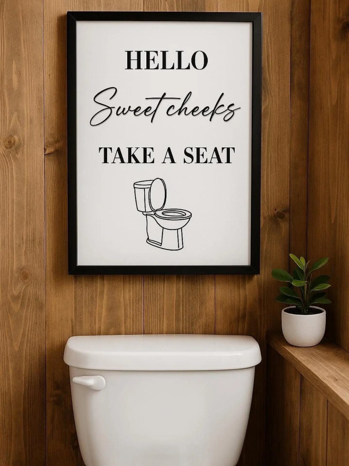 Framed wall art with humorous text hanging on a wood paneled bathroom wall above a toilet.