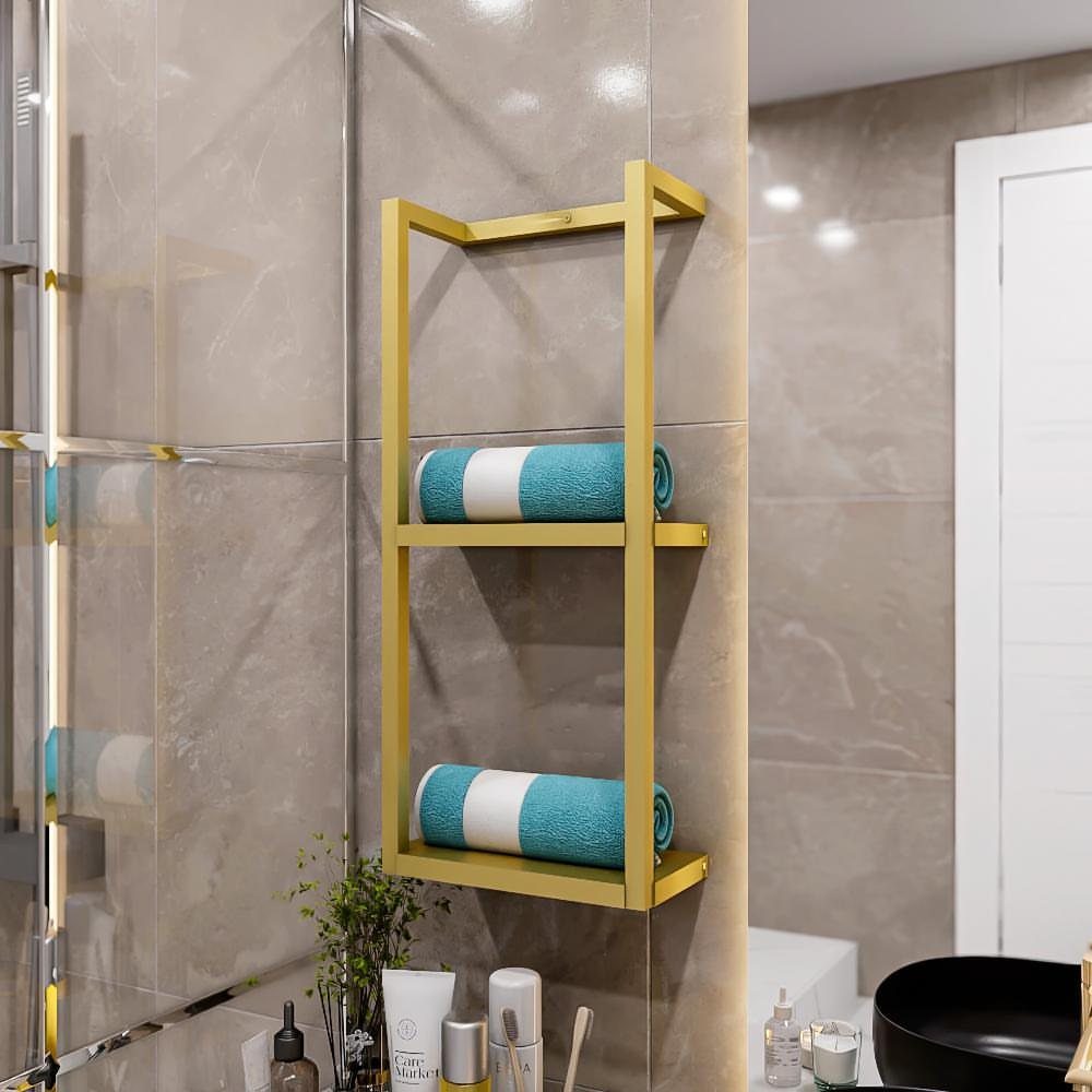 Gold metal tiered towel rack holding two rolled teal and white towels on a tiled wall.
